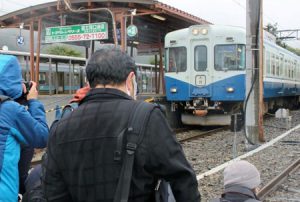 引退を間近に控える１０００系１２０２号編成にカメラを向ける鉄道ファン＝富士急行線河口湖駅